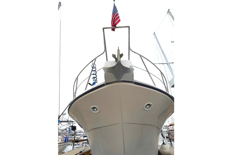 Slide: The Image of 1989 45' Californian Aft Cabin Motor Yacht with American flag, docked in marina. - 1