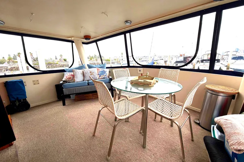 Slide: The Image of Interior of 1989 45' Californian Aft Cabin Motor Yacht with glass table and marina view. - 10