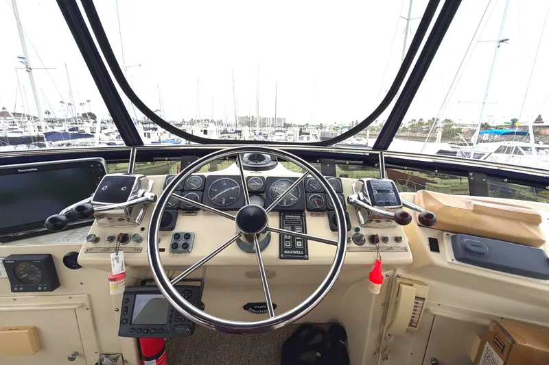 Slide: The Image of Helm of 1989 45' Californian Aft Cabin Motor Yacht in marina setting. - 12