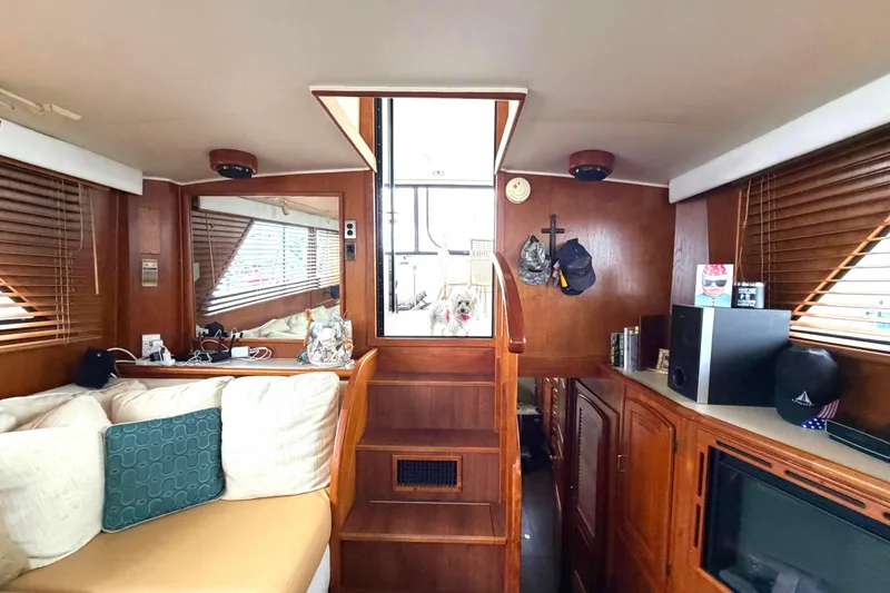 Slide: The Image of Interior of 1989 45' Californian Aft Cabin Motor Yacht with cozy seating and wooden decor. - 20