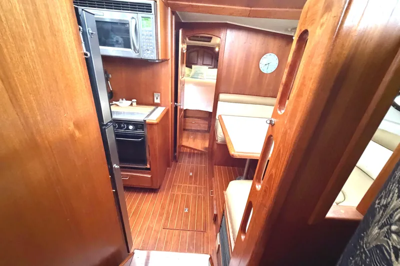 Slide: The Image of Interior of 1989 45' Californian Aft Cabin Motor Yacht with wood finish and dining area. - 25