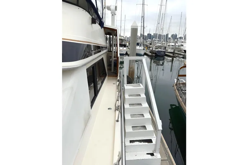 Slide: The Image of 1989 45' Californian Aft Cabin Motor Yacht docked at marina with visible walkway and stairs. - 3