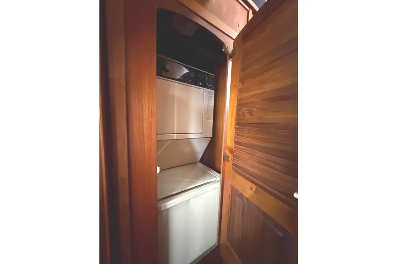 Slide: The Image of 1989 45' Californian Aft Cabin Motor Yacht laundry area with wooden cabinetry. - 33