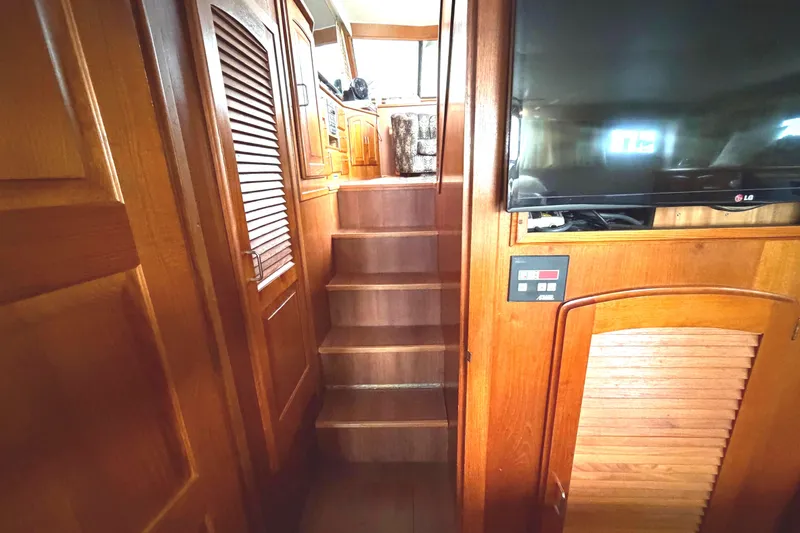 Slide: The Image of Interior of 1989 45' Californian Aft Cabin Motor Yacht with wooden stairs and TV. - 34