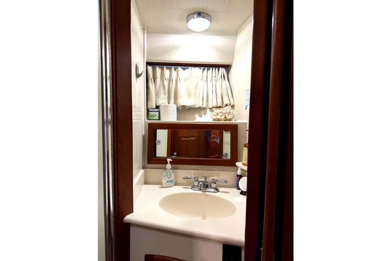 Slide: The Image of Bathroom interior of 1989 45' Californian Aft Cabin Motor Yacht, featuring sink and mirror. - 45