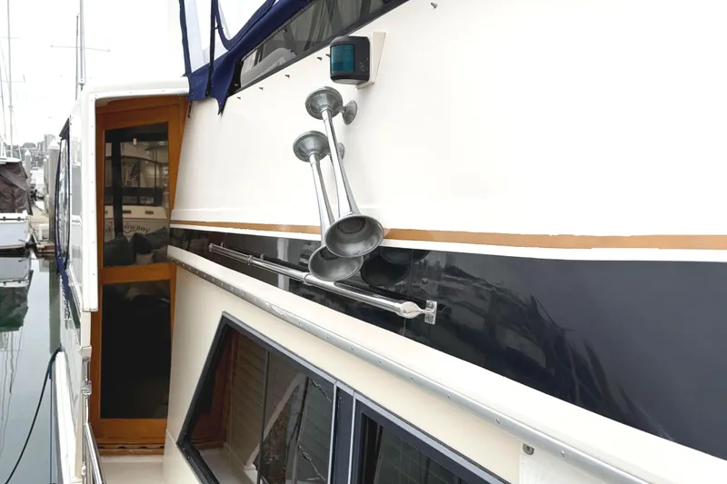 Slide: The Image of 1989 45' Californian Aft Cabin Motor Yacht exterior with nautical details and docked setting. - 5