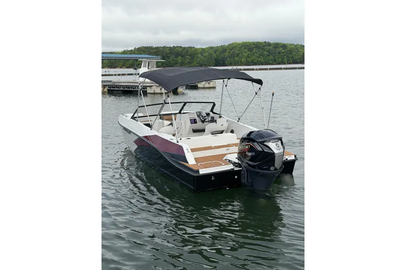 Slide: The Image of 2023 Starcraft SVX 210 DC OB boat with canopy on calm water. - 11