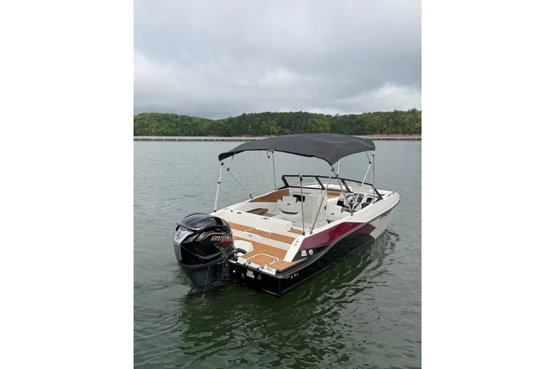 Slide: The Image of 2023 Starcraft SVX 210 DC OB boat with canopy on a calm lake. - 12