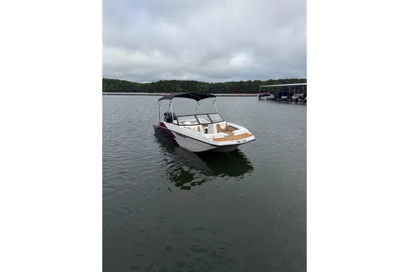 Slide: The Image of 2023 Starcraft SVX 210 DC OB boat on calm lake waters. - 14
