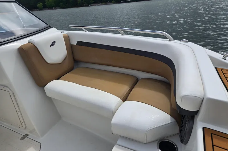 Slide: The Image of 2023 Starcraft SVX 210 DC OB boat interior with tan and white cushioned seating. - 19