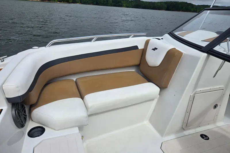Slide: The Image of 2023 Starcraft SVX 210 DC OB boat interior with tan and white seating by the water. - 20
