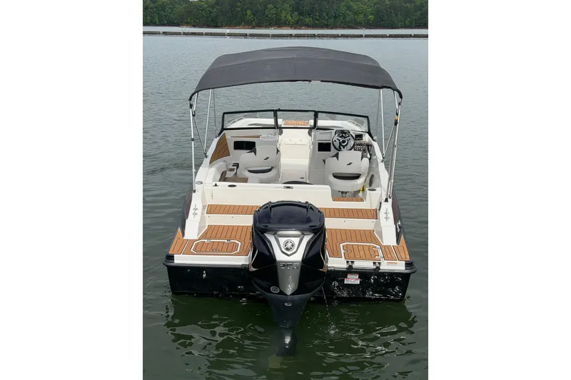 Slide: The Image of 2023 Starcraft SVX 210 DC OB boat with canopy on calm water. - 3
