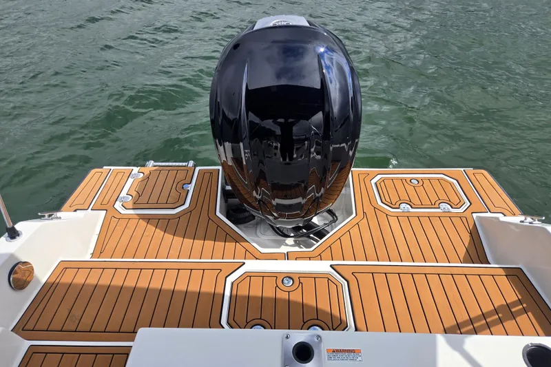 Slide: The Image of 2023 Starcraft SVX 210 DC OB boat with sleek outboard motor on water. - 4