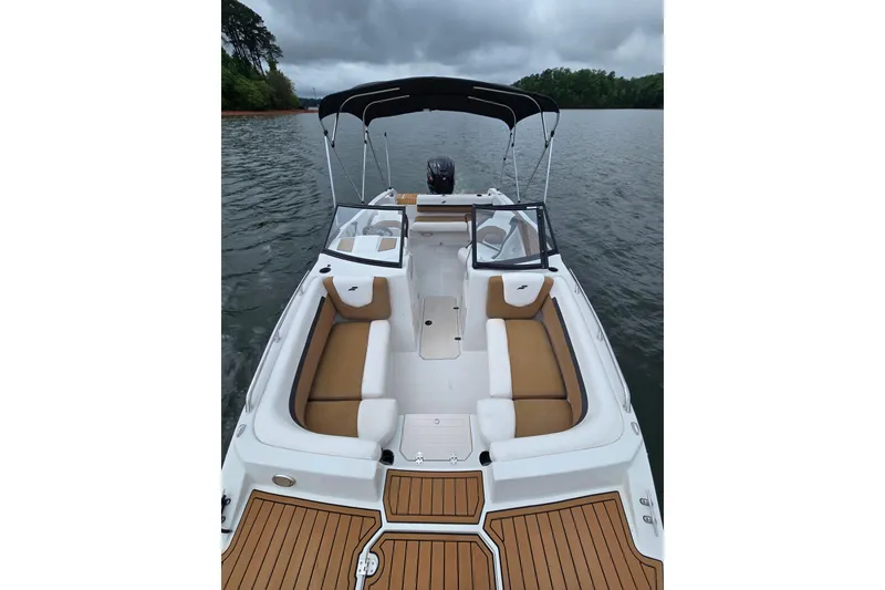 Slide: The Image of 2023 Starcraft SVX 210 DC OB boat with tan seating on a lake. - 5