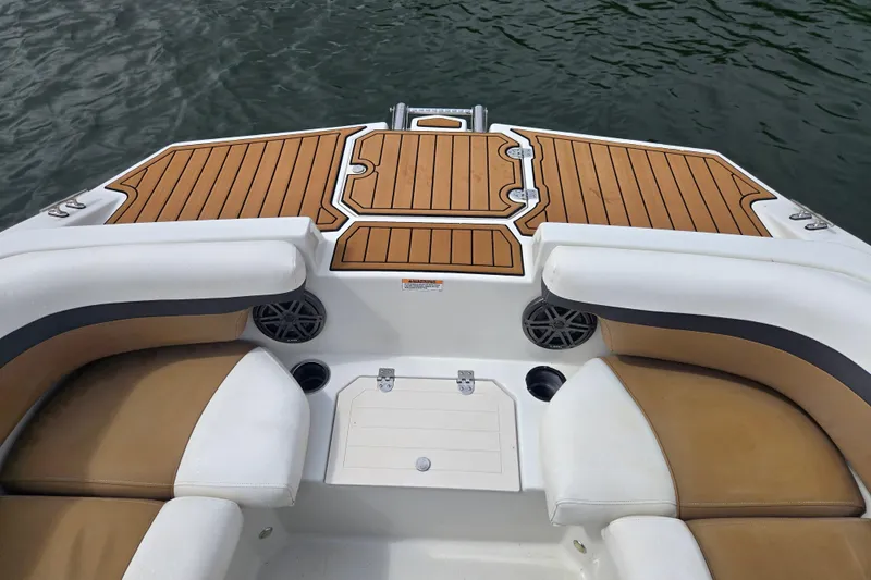 Slide: The Image of 2023 Starcraft SVX 210 DC OB boat interior with teak flooring and cushioned seating. - 6