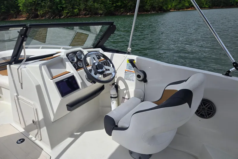 Slide: The Image of 2023 Starcraft SVX 210 DC OB boat interior with steering wheel and control panel. - 9