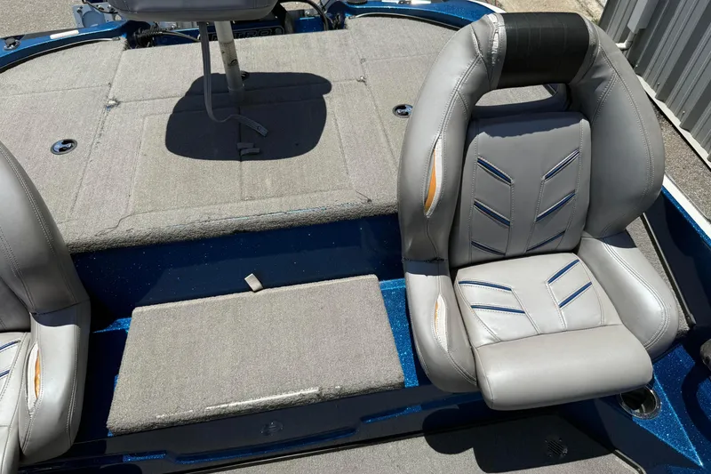 Slide: The Image of 2017 Nitro Z18 boat interior with gray cushioned seats and carpeted flooring. - 11