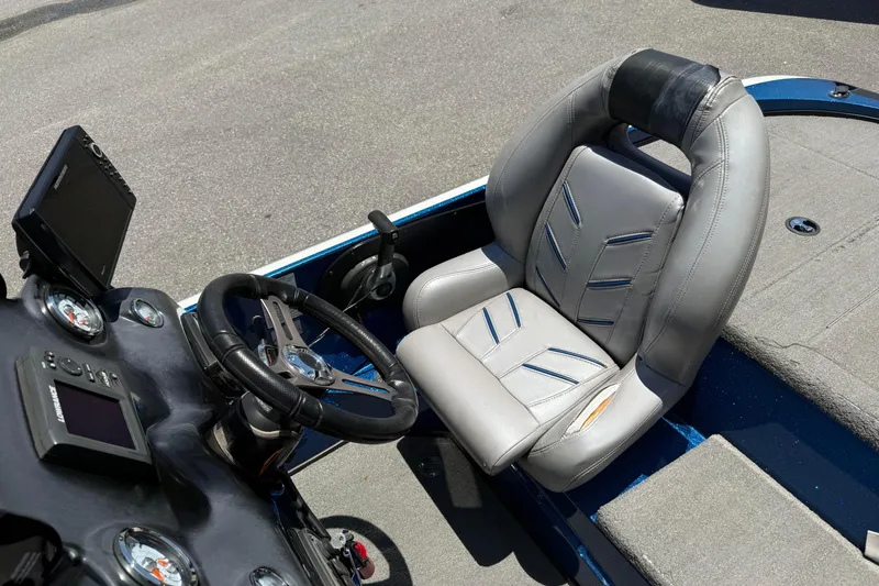 Slide: The Image of 2017 Nitro Z18 boat cockpit with steering wheel and gray seat. - 12