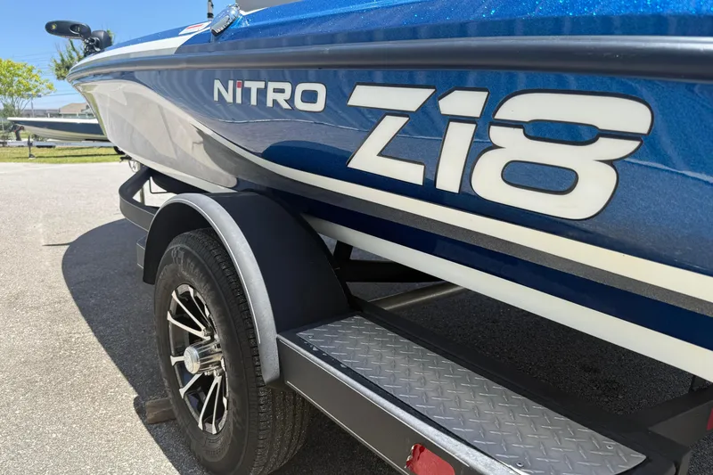 Slide: The Image of Blue 2017 Nitro Z18 boat on trailer, showcasing sleek design and branding. - 5