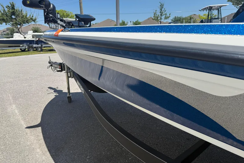 Slide: The Image of 2017 Nitro Z18 boat with sleek blue and white design on a sunny day. - 6