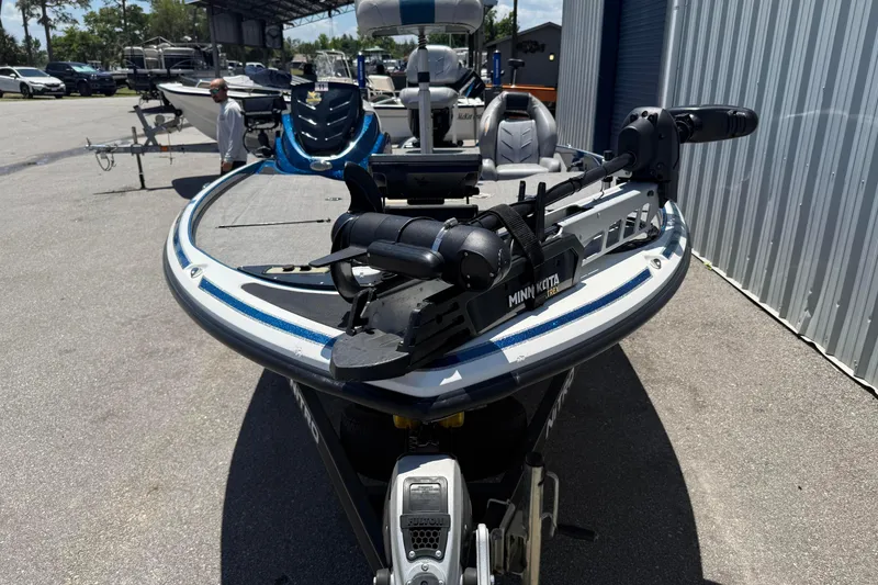 Slide: The Image of 2017 Nitro Z18 boat with Minn Kota trolling motor in a marina setting. - 8