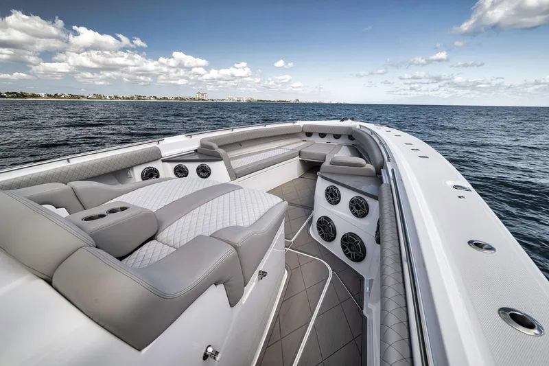 Slide: The Image of Luxurious 2025 HCB 53 Suenos boat interior with plush seating, ocean view, and clear skies. - 12