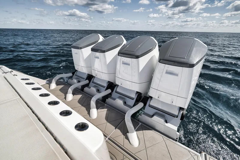 Slide: The Image of 2025 HCB 53 Suenos boat with four powerful outboard engines on open sea. - 13