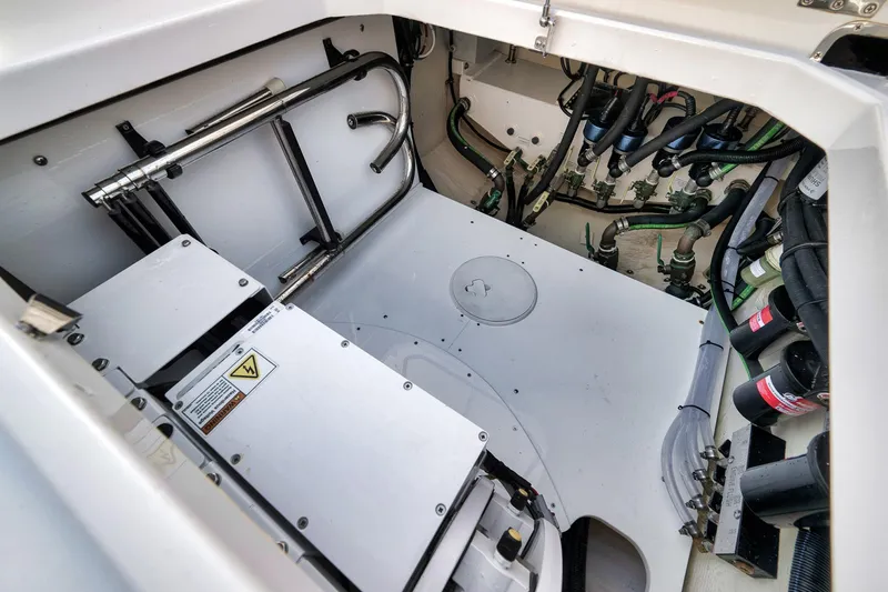 Slide: The Image of Engine compartment of 2025 HCB 53 Suenos boat, showcasing mechanical components and wiring. - 14