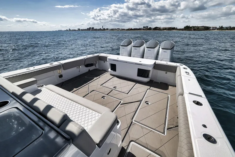 Slide: The Image of 2025 HCB 53 Suenos boat deck with quad engines, cruising on open water. - 16
