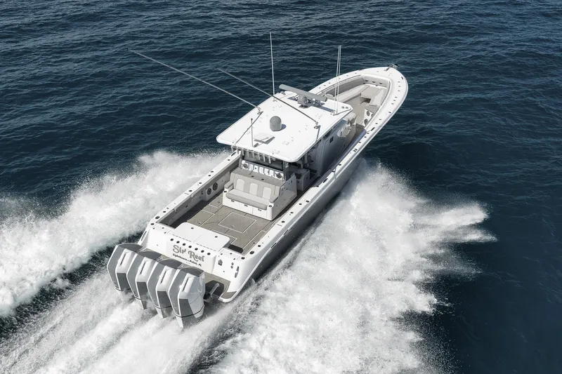 Slide: The Image of 2025 HCB 53 Suenos boat cruising on open water, showcasing powerful engines. - 8
