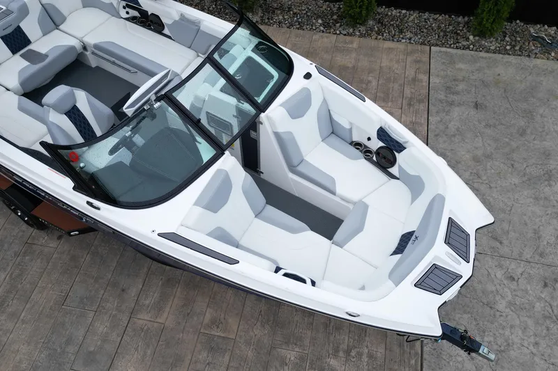 Slide: The Image of 2023 MasterCraft XT22 boat interior with white and gray seating, aerial view. - 10