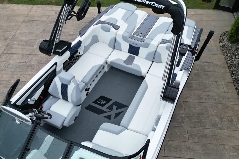 Slide: The Image of 2023 MasterCraft XT22 boat interior with sleek white seating and modern design. - 12