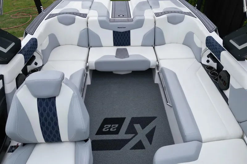 Slide: The Image of 2023 MasterCraft XT22 boat interior with luxurious seating and modern design. - 13