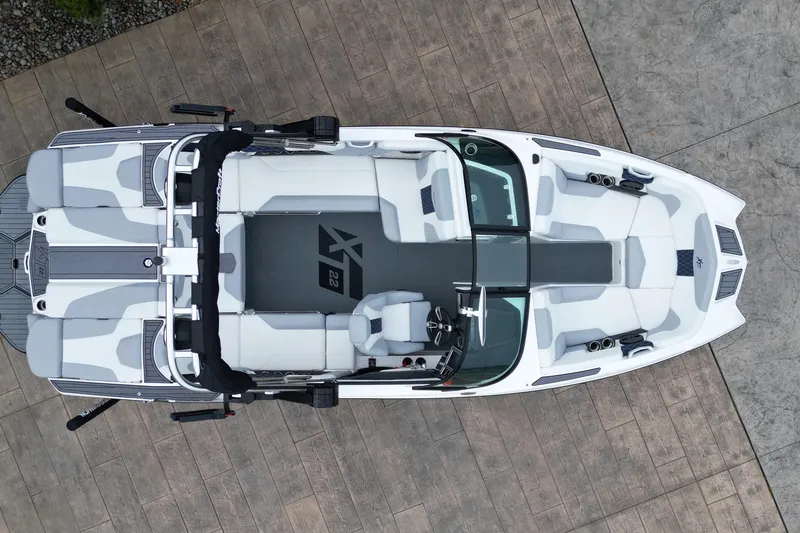 Slide: The Image of Top view of 2023 MasterCraft XT22 boat with sleek white and gray interior design. - 14