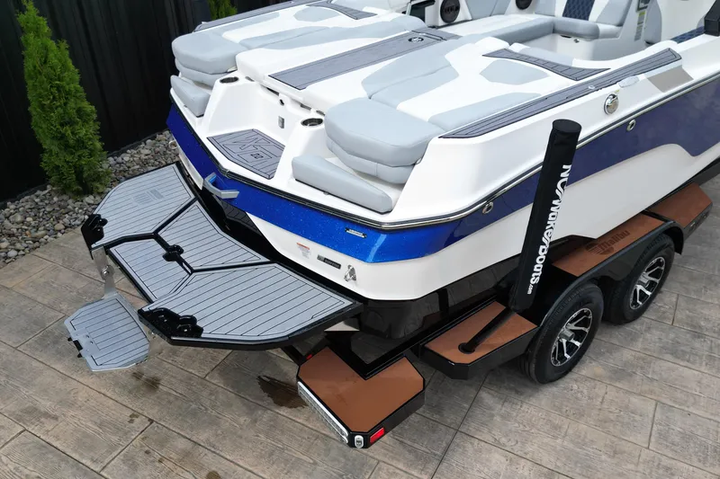 Slide: The Image of 2023 MasterCraft XT22 boat on trailer, featuring sleek design and modern seating. - 6