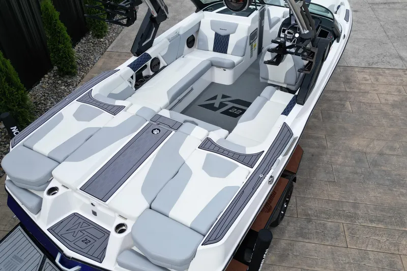 Slide: The Image of 2023 MasterCraft XT22 boat interior with sleek seating and modern design. - 7