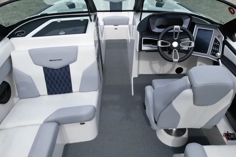 Slide: The Image of 2023 MasterCraft XT22 boat interior with modern steering and seating design. - 8