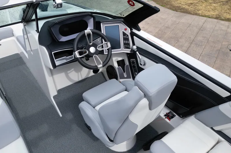 Slide: The Image of 2023 MasterCraft XT22 boat interior with modern steering and control panel. - 9