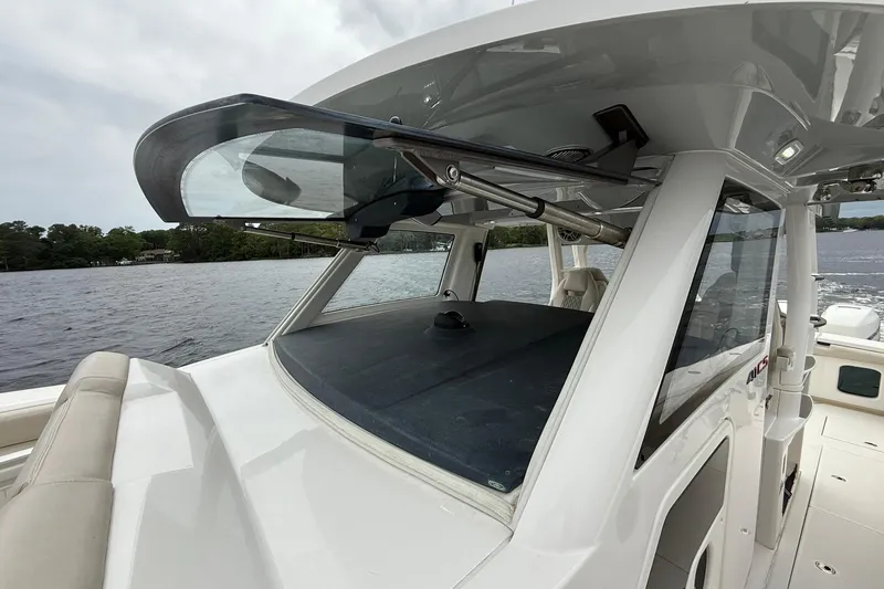 Slide: The Image of 2022 Solace 41CS boat with sleek design on a calm waterway. - 13