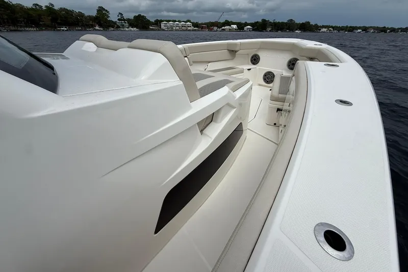 Slide: The Image of 2022 Solace 41CS boat interior with sleek seating and modern design on open water. - 14