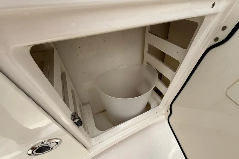Slide: The Image of Storage compartment with white bucket in 2022 Solace 41CS boat. - 18