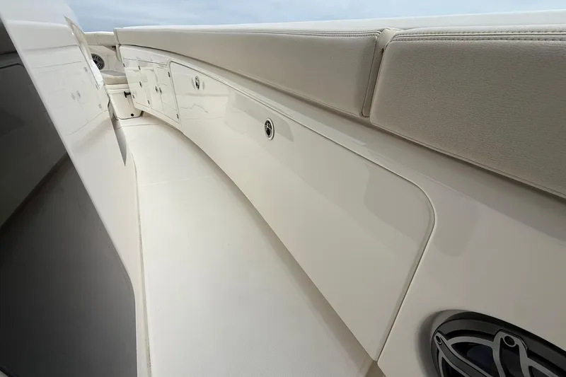 Slide: The Image of 2022 Solace 41CS boat interior with sleek white seating and storage compartments. - 20
