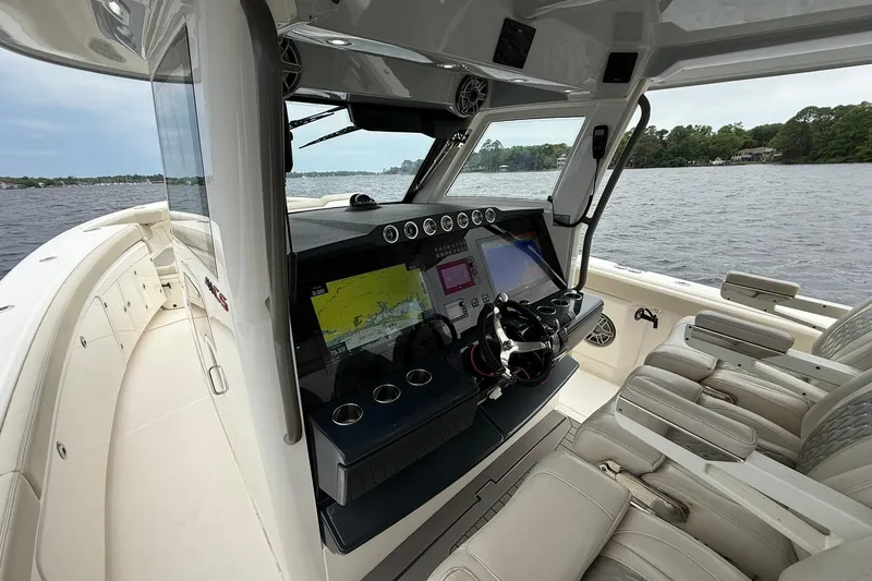 Slide: The Image of Interior view of 2022 Solace 41CS boat cockpit with navigation screens and seating. - 23