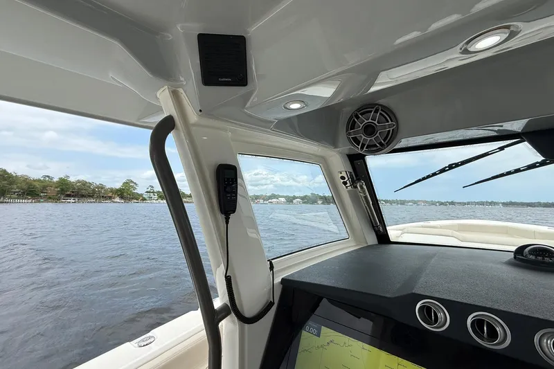 Slide: The Image of Interior view of 2022 Solace 41CS boat, featuring navigation equipment and scenic waterway. - 25