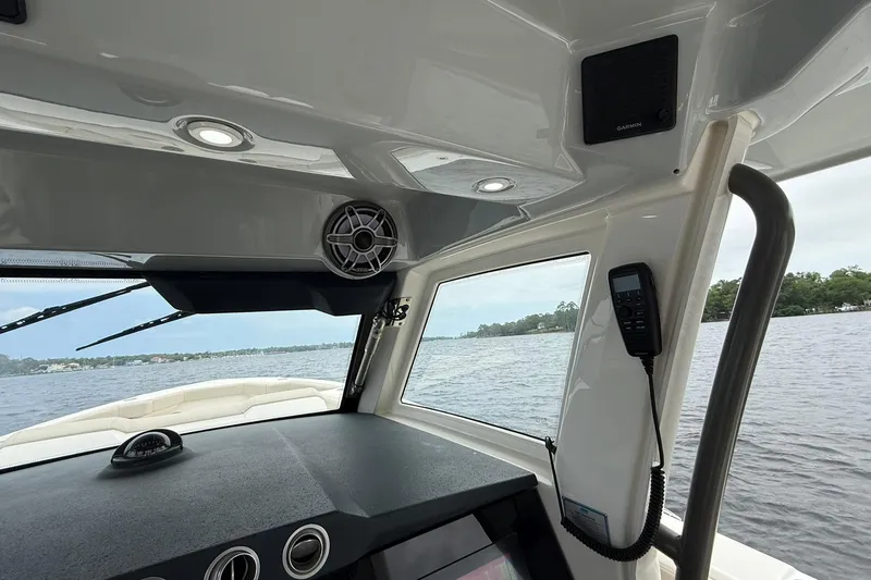 Slide: The Image of Interior view of 2022 Solace 41CS boat cockpit with water in the background. - 27
