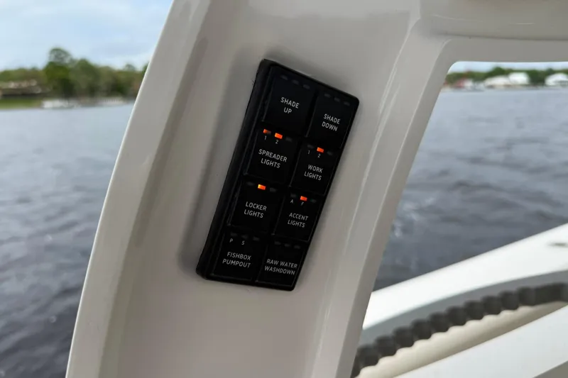 Slide: The Image of Control panel on 2022 Solace 41CS boat, featuring various light and pump switches. - 34