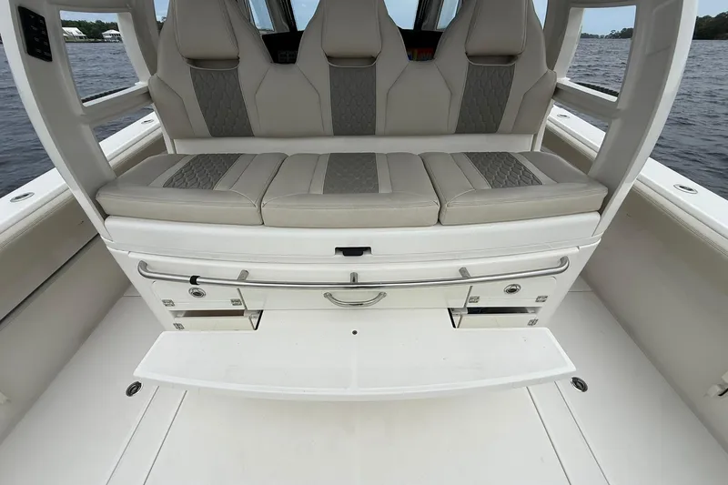 Slide: The Image of 2022 Solace 41CS boat seating area with storage compartments, on a calm water backdrop. - 35