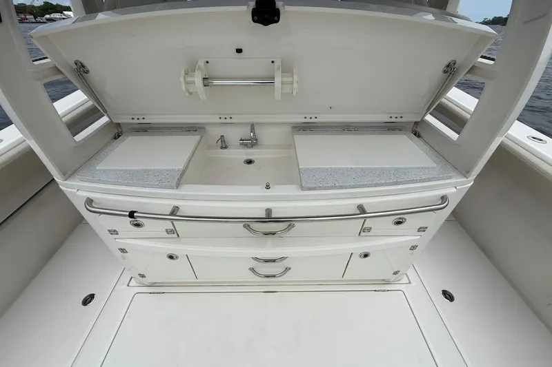 Slide: The Image of Outdoor kitchen setup on a 2022 Solace 41CS boat, featuring sink and storage. - 36