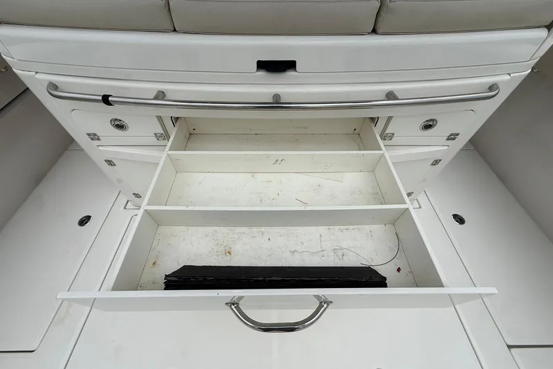 Slide: The Image of Open storage compartment on a 2022 Solace 41CS boat, featuring multiple shelves. - 37