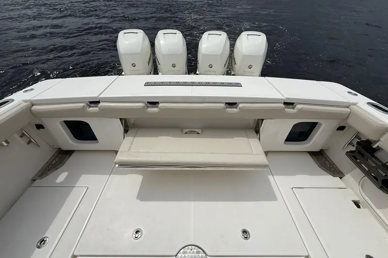 Slide: The Image of 2022 Solace 41CS boat deck with four powerful outboard engines on water. - 41
